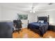 Bedroom with hardwood floors and a dark wood bed frame at 8304 Sandstone Ct, Tampa, FL 33615