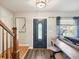 Bright entryway with hardwood floors, a navy door, and a wooden staircase at 8304 Sandstone Ct, Tampa, FL 33615
