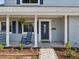 Front porch with rocking chairs and landscaping at 8304 Sandstone Ct, Tampa, FL 33615