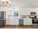 Renovated kitchen featuring white shaker cabinets, stainless steel appliances, and quartz countertops at 8304 Sandstone Ct, Tampa, FL 33615