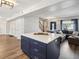 Modern kitchen with a navy island, white cabinets, and quartz countertops at 8304 Sandstone Ct, Tampa, FL 33615