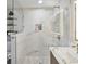 Spa-like shower with marble tile and glass enclosure at 8304 Sandstone Ct, Tampa, FL 33615