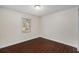 Simple bedroom with dark wood-look flooring and neutral walls at 949 Old Welcome Rd, Lithia, FL 33547