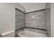 Clean bathroom with a bathtub and updated tile at 10110 Winsford Oak Blvd # 612, Tampa, FL 33624