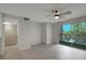 Living room with grey floors and access to balcony at 10110 Winsford Oak Blvd # 612, Tampa, FL 33624