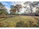 Large backyard featuring a home with a screened enclosure at 1130 Barranca Ave, Spring Hill, FL 34609