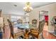 Dining area with glass table, ornate chairs, and access to backyard at 1130 Barranca Ave, Spring Hill, FL 34609