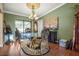 Elegant dining room with glass-top table and ornate chairs at 1130 Barranca Ave, Spring Hill, FL 34609