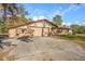 House exterior featuring a two-car garage and stone accents at 1130 Barranca Ave, Spring Hill, FL 34609