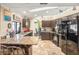 Kitchen with granite countertops, dark wood cabinets, and breakfast bar at 1130 Barranca Ave, Spring Hill, FL 34609