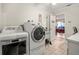 Bright laundry room with washer, dryer and access to the pool table at 1130 Barranca Ave, Spring Hill, FL 34609