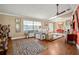 Living area with hardwood floors, leopard print rug, and ceiling fan at 1130 Barranca Ave, Spring Hill, FL 34609