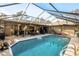Enclosed pool area with seating and a grill at 1130 Barranca Ave, Spring Hill, FL 34609