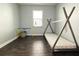 Cozy bedroom with dark wood floors and a teepee bed at 11652 Palmetto Pine St, Riverview, FL 33569