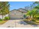 Well-maintained single-Gathering home with lovely landscaping, mature trees, and a convenient two-car garage at 11652 Palmetto Pine St, Riverview, FL 33569