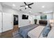 This spacious main bedroom features hardwood floors, ceiling fans, a TV, and an open walk-in closet at 11652 Palmetto Pine St, Riverview, FL 33569