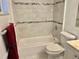 Bright bathroom featuring marble-look tile walls and a soaking tub at 1254 E 113Th Ave # C110, Tampa, FL 33612