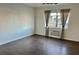 Well-lit bedroom with wood floors, neutral walls, and an AC unit under the window at 1254 E 113Th Ave # C110, Tampa, FL 33612