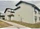 Exterior shot of building with gray trim and pale siding and a sidewalk at 1254 E 113Th Ave # C110, Tampa, FL 33612
