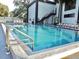 Inviting outdoor swimming pool with lounge chairs and metal ladders at 1254 E 113Th Ave # C110, Tampa, FL 33612