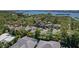 An aerial shot showcases homes in a neighborhood by the water with mature trees at 13182 72Nd Ter, Seminole, FL 33776