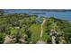 A scenic overhead shot highlights a grassy field with waterfront views and city skyline in the background at 13182 72Nd Ter, Seminole, FL 33776