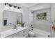 Modern bathroom with white vanity, bathtub, and stylish fixtures at 13182 72Nd Ter, Seminole, FL 33776