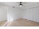 Bright bedroom with light wood floors, ceiling fan, and ample closet space at 13182 72Nd Ter, Seminole, FL 33776