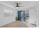 Bedroom with wood floors, sliding door to deck, and ceiling fan at 13182 72Nd Ter, Seminole, FL 33776