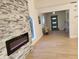 Bright entryway with a modern fireplace and light wood flooring at 13182 72Nd Ter, Seminole, FL 33776
