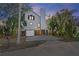 Two-story house with gray siding, a large window, and a two-car garage at 13182 72Nd Ter, Seminole, FL 33776