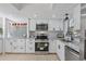 Updated kitchen with white cabinets, stainless steel appliances, and granite countertops at 13182 72Nd Ter, Seminole, FL 33776