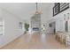Open living area with vaulted ceilings, a stone fireplace, and light wood floors at 13182 72Nd Ter, Seminole, FL 33776