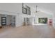Spacious living room with high ceilings, sliding glass doors, and hardwood floors at 13182 72Nd Ter, Seminole, FL 33776