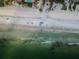 Aerial view of beach with ocean waves and people enjoying the sand at 19725 Gulf Blvd # 46, Indian Shores, FL 33785