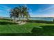 Landscaped backyard with waterfront views, dock, and picnic area at 19725 Gulf Blvd # 46, Indian Shores, FL 33785