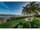 Waterfront backyard with grill, seating area, and lush landscaping at 19725 Gulf Blvd # 46, Indian Shores, FL 33785