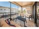 Spacious screened balcony with seating and partial water view at 19725 Gulf Blvd # 46, Indian Shores, FL 33785