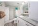 Bathroom with granite countertop, white cabinets, and a shower at 19725 Gulf Blvd # 46, Indian Shores, FL 33785