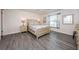 Light and airy bedroom with a queen-size bed and wood flooring at 19725 Gulf Blvd # 46, Indian Shores, FL 33785