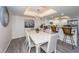Bright dining area with a white table and gray chairs, adjacent to a kitchen at 19725 Gulf Blvd # 46, Indian Shores, FL 33785