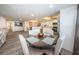 Round wooden dining table with four beige chairs in open concept space at 19725 Gulf Blvd # 46, Indian Shores, FL 33785