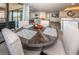 Round dining table with four chairs, overlooking the living room at 19725 Gulf Blvd # 46, Indian Shores, FL 33785