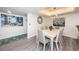 Charming dining room with white table and gray chairs at 19725 Gulf Blvd # 46, Indian Shores, FL 33785