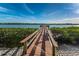 Wooden community dock extending over calm waters at 19725 Gulf Blvd # 46, Indian Shores, FL 33785