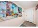 Bright condo entryway with beach themed art at 19725 Gulf Blvd # 46, Indian Shores, FL 33785
