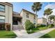 Condo building exterior with stairs and landscaping at 19725 Gulf Blvd # 46, Indian Shores, FL 33785