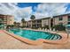 Inviting community pool with lounge chairs and patio area at 19725 Gulf Blvd # 46, Indian Shores, FL 33785