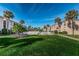 Inviting pool area with lush landscaping and palm trees at 19725 Gulf Blvd # 46, Indian Shores, FL 33785
