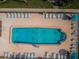 Community pool with plenty of lounge chairs at 19725 Gulf Blvd # 46, Indian Shores, FL 33785